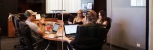 Planning meeting with four people sitting around a table