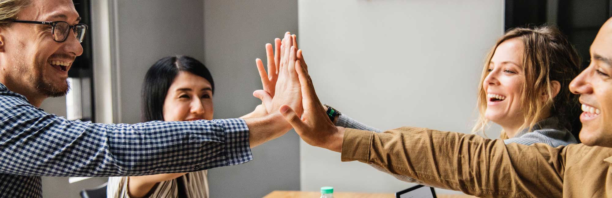 Team doing high fives to show success