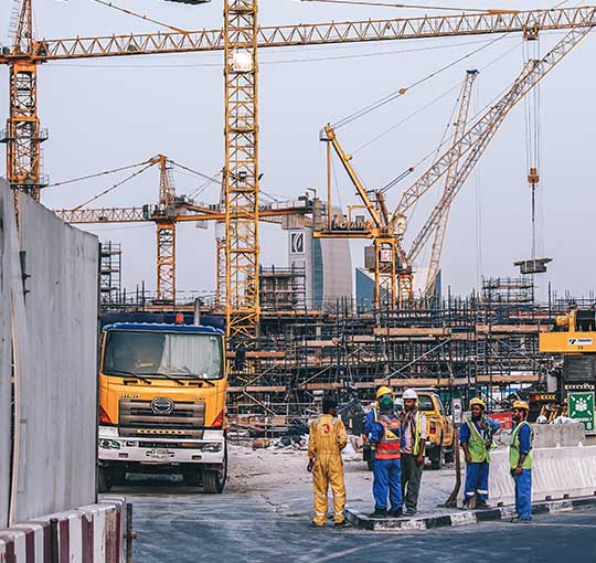 Construction industry: Construction site with cranes and workers